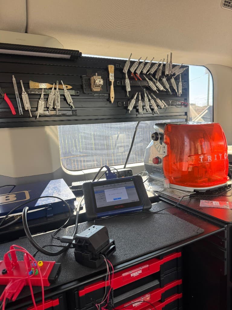 Emergency car key fob programming tools in Louisville mobile locksmith van — Autel, Triton cutter, Lishi